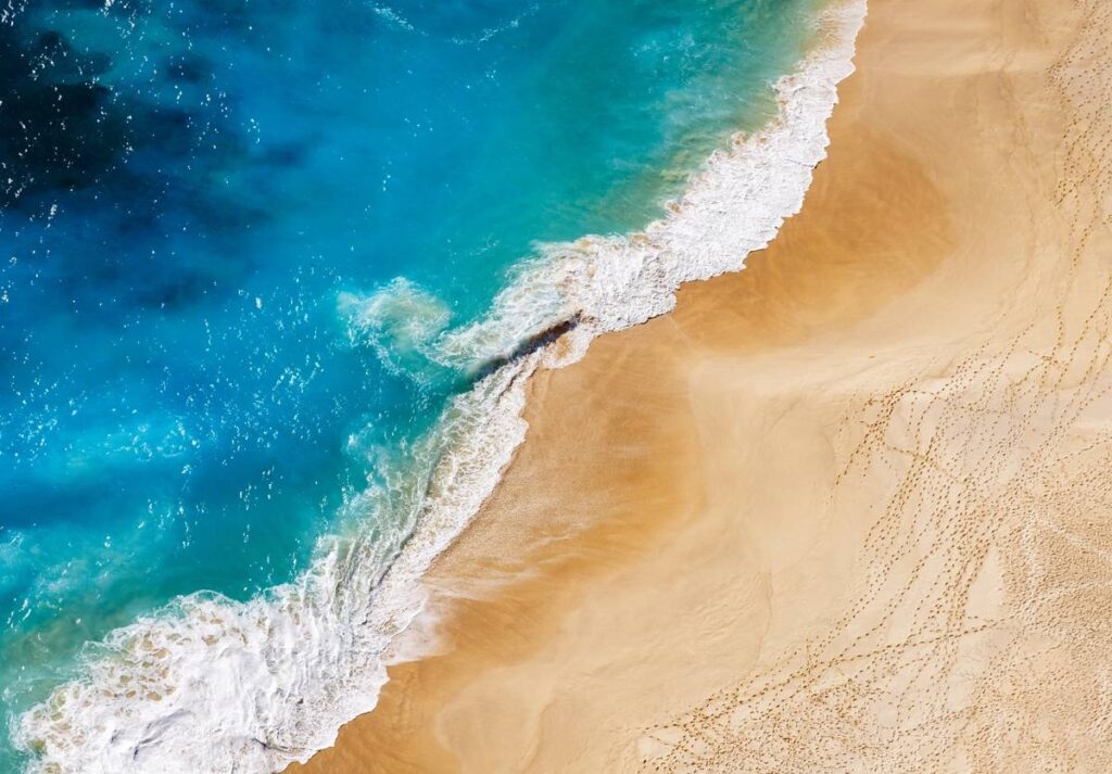 Aerial view to tropical sandy beach and blue ocean